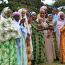 A group of Ethiopian women and small children in brightly colored clothing