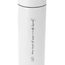 A tall, white MiiR travel mug with a screw on flip top and engraved with "Specialty coffee as a vehicle for positive change" and Dean's signature bean