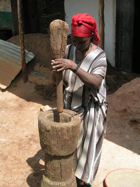 Ethiopian woman using a large mortar and pestle