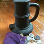 A thunder mug and a small, purple bag with pirates booty spilling out