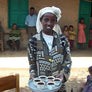An Ethiopian girl carrying a small tray of coffee cups