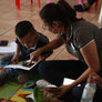 A teacher helping a young child read