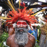 A man wearing a traditional headdress and face paint