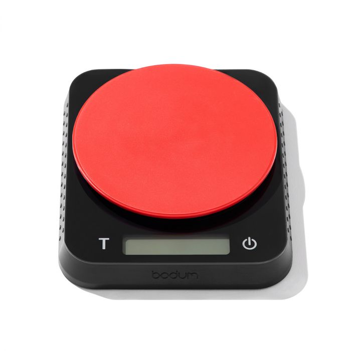 a  square black scale with a round red weighing surface