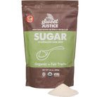 A bag of Sweet Justice Sugar, with a small pile of sugar in front