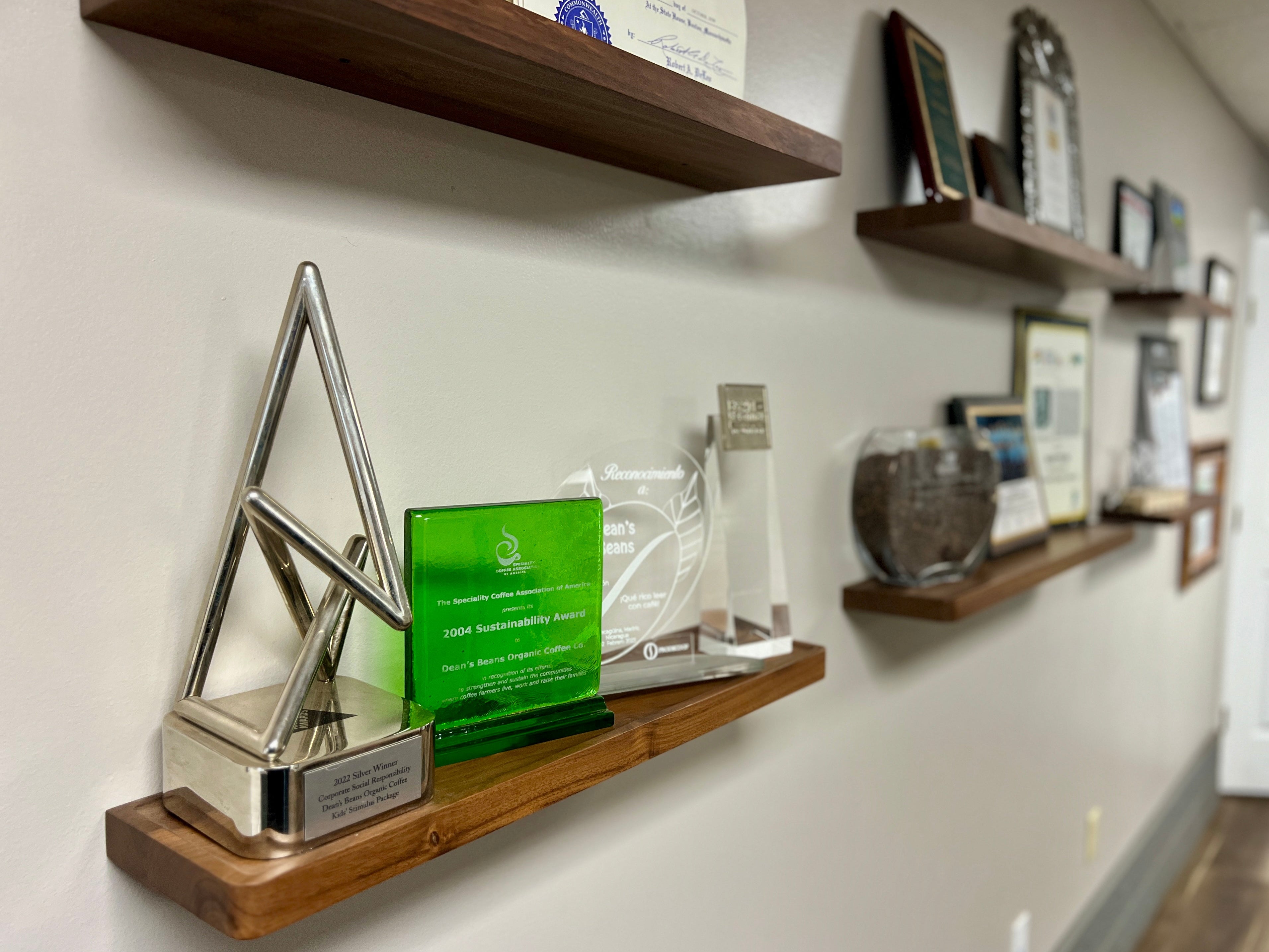 wooden shelves along a wall with awards