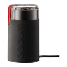 a black coffee grinder with a clear lid and red button