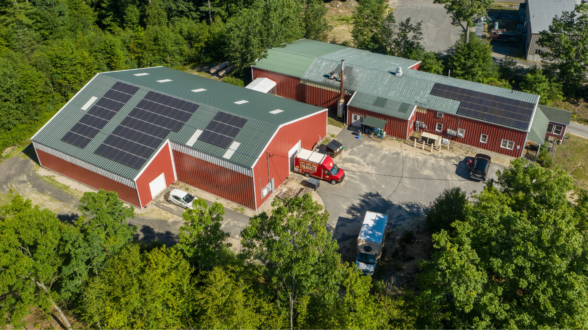 Aerial view of the dean's beans roastery with an extensive array of solar panels on the roof.