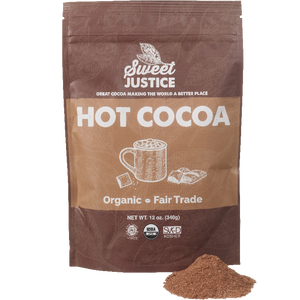 A bag of Sweet Justice Hot Cocoa with a small pile of cocoa mix in front