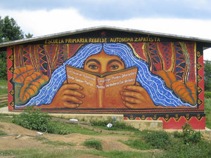A mural featuring a person with long blue hair reading a book