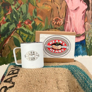 A travel mug and a box of Steeped packets in front of a mural