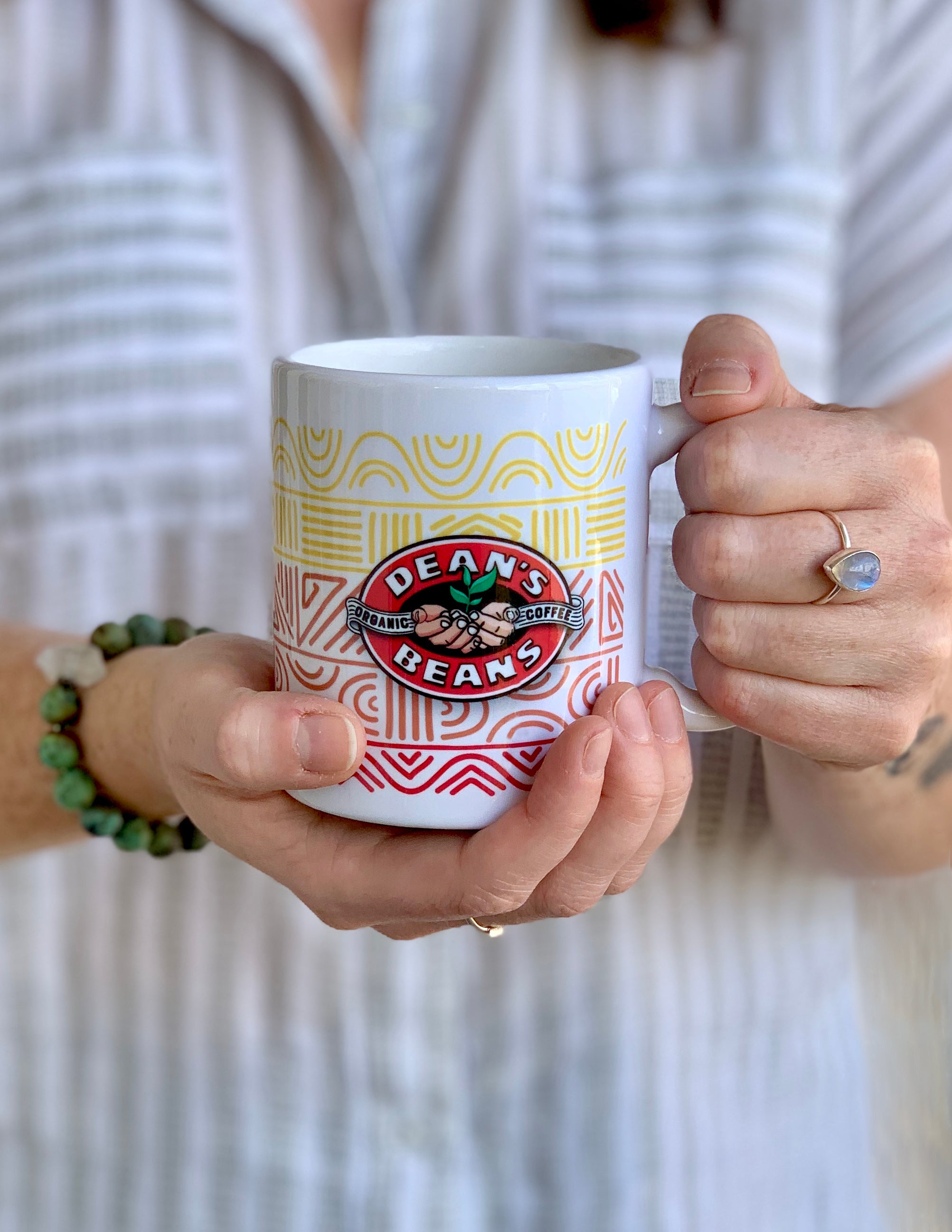 Person holding the white ceramic mug